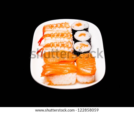 sushi in white plate on black background