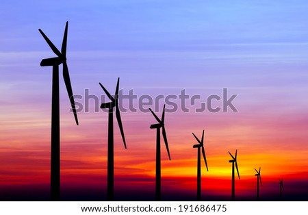 wind turbine silhouette on colorful sunset abstract for green earth concept