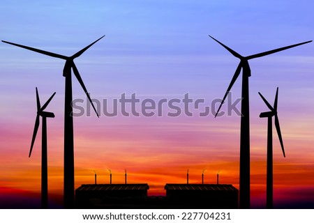 Carbon credits concept,silhouette wind turbine generator with factory emissions of carbon dioxide on sunset background