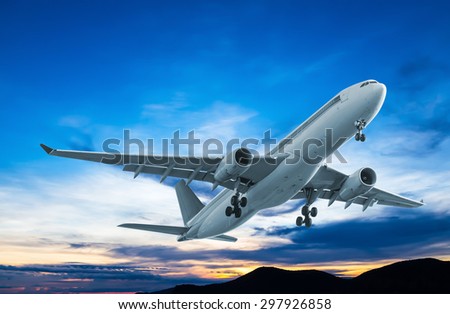 Commercial airplane flying at sunset Commercial airplane flying at sunset