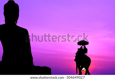 silhouette elephant with tourist in front of big buddha at sunset