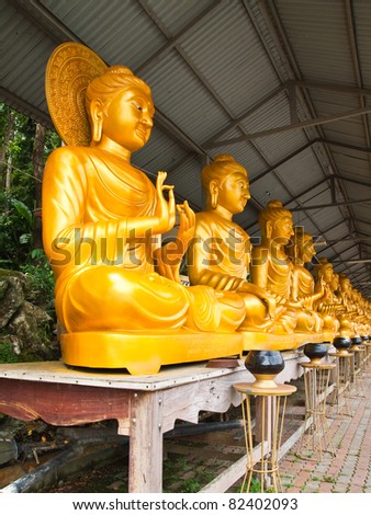 Row of golden Buddha in Thai art style at Thai temple,North East of Thailand.
