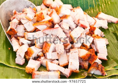 Grilled suckling pig cut as small piece on banana leaved