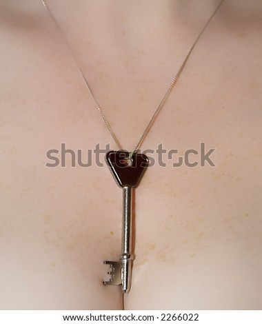 A key on a chain around a beautiful womans neck