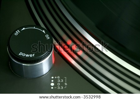 Red strobe light on record player turntable