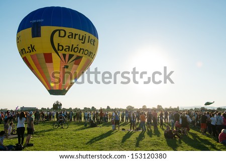 PIESTANY, SLOVAKIA - SEPTEMBER 6: Crowds watch take off of colorfull balloon during 1st Balloon megafiesta on September 6th, 2013 in Piestany, Slovakia