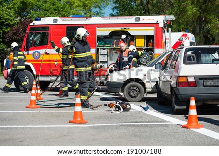 PEZINOK, SLOVAKIA - MAY 4, 2014: Volunteer fire fighters participate in a vehicle extrication demonstration and training in Pezinok, Slovakia Firefighters training exercise