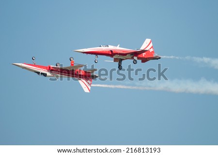 PAYERNE, SWITZERLAND - SEPTEMBER 6: Members of Patrouille Suisse aerobatic team members flying in close distance on AIR14 airshow in Payerne, Switzerland on September 6, 2014