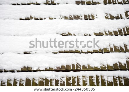 Texture of wooden roof tiles covered with snow