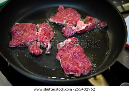 Beef flank steaks on hot fraying pan