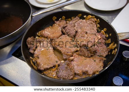 Beef flank steaks with sauce on pan