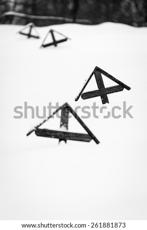 Wooden crosses from WWI covered by snow - black and white picture