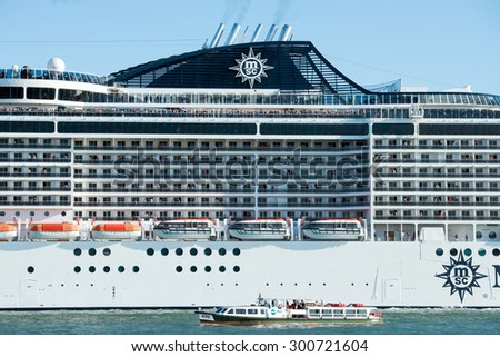 VENICE, ITALY - SEPTEMBER 14, 2014: MSC Fantasia cruise ship with passengers floats in Venice, Italy. MSC Fantasia is the largest cruise ship ever built for a European ship owner.