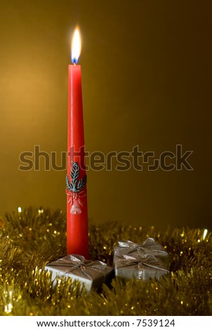 red candle with Xmas motive and silver boxes