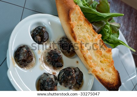 detail of tasty garlic fried snails with garlic bread