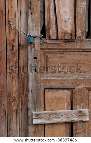 old broken wooden door locked by chain