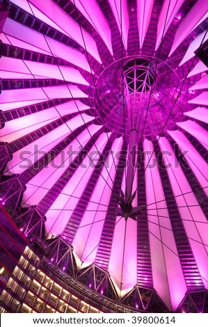 futuristic roof of commercial center at the Potsdamer Platz in Berlin lit by violet light, Germany