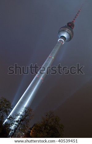 TV tower lit by light in the night, Berlin, Germany