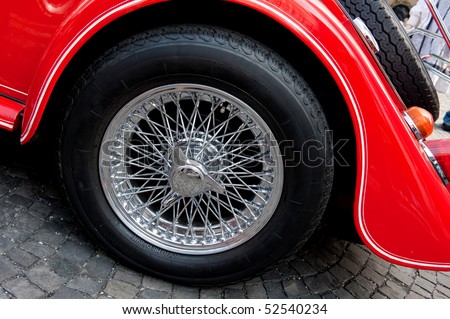 detail of rear wheel of red vintage car