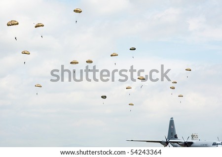 PIESTANY, SLOVAKIA - MAY 29: soldiers standing on C-130J Super Hercules are observing paratroopers in the air during airshow in Piestany, Slovakia, May 29, 2010