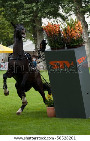 BRATISLAVA, SLOVAKIA - AUGUST 5: OTSCHMAIER Wolfgang on horse ROYAL KING OF DARKNESS fails on first hurdle during qualification to Grand Prix CSIO-W*** August 5, 2010 in Bratislava, Slovakia