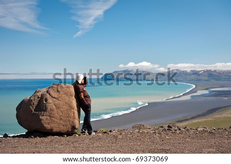 young woman looking at amazing Icelandic landscape