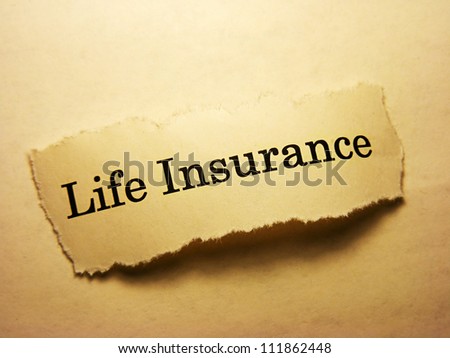 Torn paper with life insurance text. Life insurance concept.