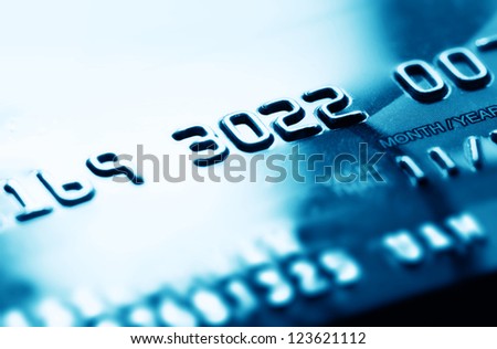 Credit card in blue tone. Selective focus.