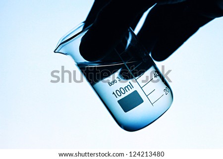 Laboratory glass in arm. Laboratory concept.