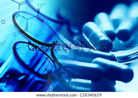 Medical background with pills and test tube. Blue tone.