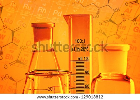 Laboratory glassware in yellow light with chemical formula. Science concept.