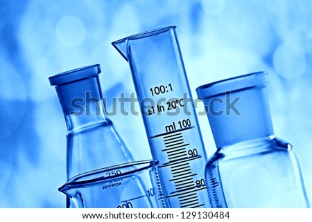 Laboratory glassware in blue light. Science concept.