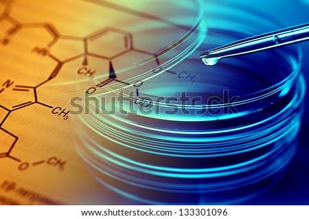 Petri dishes, pipette and chemical formula. Laboratory concept.