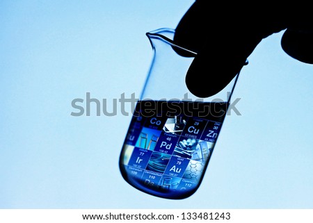 Laboratory glass in arm with science tools inside. Laboratory concept.