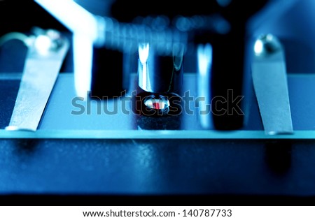 Microscope with biological material. Blue tone.