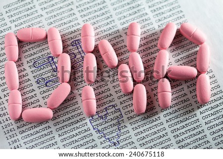 DNA text made from pink pills over paper with DNA data.Science c
