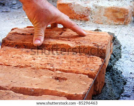 Hands of a construction mason worker bricklayer