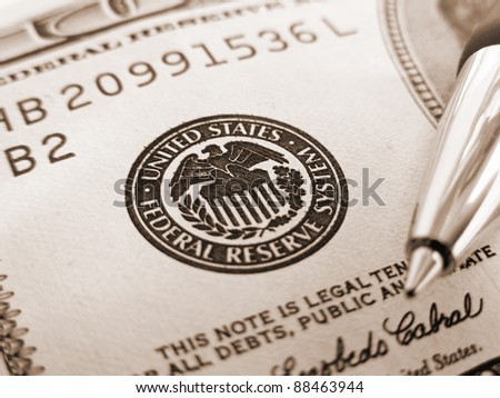 Symbol of Federal reserve system on dollar and pen. Finance system concept.
