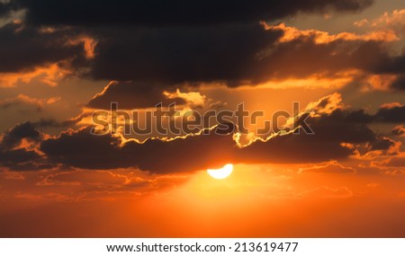 red sunset with clouds photographed by a telephoto lens