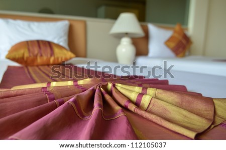 Messy luxurious bed with pillow and quilt cover