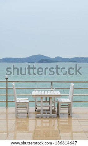 Dining table on a beach close to the ocean