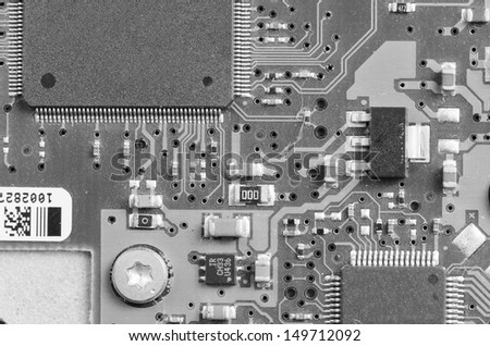 Closeup of electronic circuit board with processor in black and white
