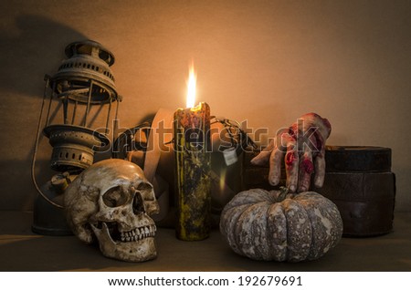 Still life with skull, old lamp, pumpkin and candle
