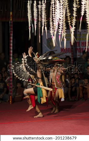 DENPASAR, BALI, INDONESIA - JUNE 14: Unidentified dancer from the indigenous Borneo people performs a traditional Borneo dance at Bali Art Festival on June 14, 2014 in Denpasar, Indonesia