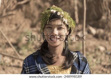 MANDALAY - MYANMAR - JANUARY 21, 2015: An unidentified smiling Burmese girl on January 21, 2014 in Mandalay, Myanmar. In 2015 an ongoing conflict started between Buddhists and Muslims in Myanmar.