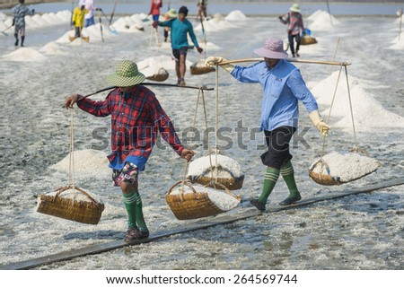 PETCHABURI- MAR 28 : Workers are helping to transport salt from salt. Ban Laem, Phetchaburi, Thailand on March 28, 2015