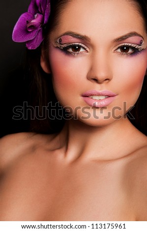 pretty brunette woman with orchid in hair