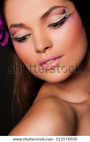 pretty brunette woman with orchid in hair
