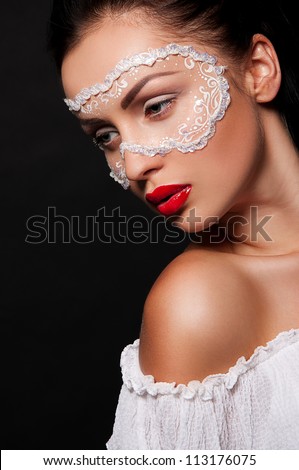 sexy brunette woman with face art like mask on face