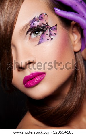 sexy woman with creative makeup and body art elements in violet color